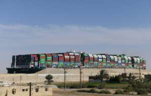 The MV Ever Given's huge cargo of containers towers over its superstructure in this photograph taken from the adjacent desert after it resumed its journey through the Suez Canal. By Ahmad HASSAN (AFP)