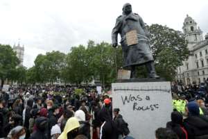 The statue of former British Prime Minister Winston Churchill is seen disfigured during a Black Lives Matter protest in London last June.  By ISABEL INFANTES (AFP)