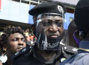 The police chief of Nigeria's economic hub looks on at protesters demonstrating against police brutality. By PIUS UTOMI EKPEI (AFP)