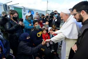The pope visited migrants at the Mavrovouni camp on the island of Lesbos and told them he was trying to help them. By - (VATICAN MEDIA/AFP)