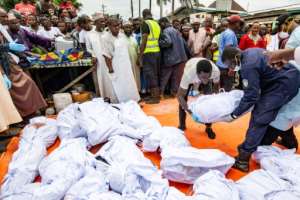 The victims' bodies are prepared for burial. By Carielle DOE (AFP)