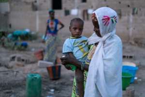 The violence in central Mali has caused many to flee their homes -- here, a woman and her child are pictured among a group of people who have taken shelter in Dialokorobougou, near Bamako. By Sebastien Rieussec (AFP)