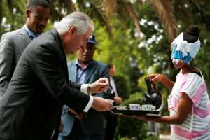 Then US secretary of state Rex Tillerson receives a cup of brewed coffee during a traditional ceremony at the US embassy in Addis Ababa in March 2018. By JONATHAN ERNST (POOL/AFP/File)