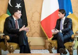 This photo handed out on January 11, 2020 by the Palazzo Chigi Press Office shows Italian Prime Minister Giuseppe Conte (R), who said Italy would make an