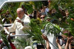 Throngs of cheering faithful waving palm fronds lined the streets of Port Louis as the popemobile shuttled the Argentine pontiff to the hilltop Mary Queen of Peace Monument. By Tiziana FABI (AFP)