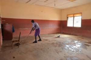 Time to clean: A student readies a classroom at an Accra school. By Nipah Dennis (AFP)