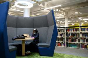 To study in Coventry University's library, students must reserve a place under virus measures. By OLI SCARFF (AFP)