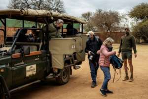 Tourists wearing coronavirus face masks at the Dinokeng Game Reserve just outside Pretoria. By Michele Spatari (AFP)