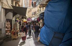 Tourists and locals walk in the medina in Fez, listed as a UNESCO World Heritage Site in 1981 for its