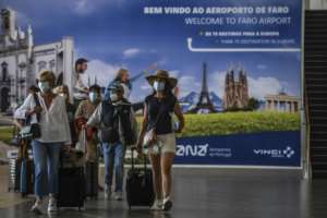 Tourists arrive at Faro airport in Portugal as the country eased restrictions. By PATRICIA DE MELO MOREIRA (AFP)