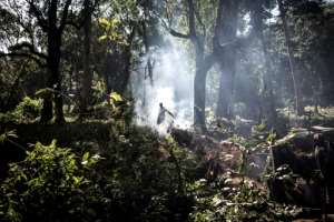 Troops cross an enemy position recently captured in the Wago Forest. By John WESSELS (AFP)
