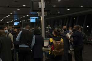 Travellers thronged Johannesburg international airport, desperate to catch last flights to countries that have imposed sudden travel bans. By Dimitri KORCZAK (AFP)