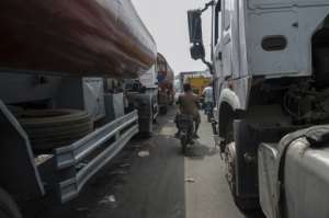 Trucks wait in line to get to Lagos port. The facility has a poor reputation for efficiency and corruption. By Stefan HEUNIS (AFP)