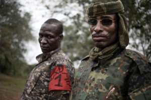 On March 16, 2019, two brigade leaders of the UPC armed group pose for photos in the town of Bokolobo, near Bambari. By FLORENT VERGNES (AFP / File)