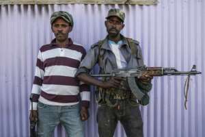 Two members of the Amhara militia in Mai Kadra, where at least 600 civilians were killed, according to Rthiopia's rights watchdog. By EDUARDO SOTERAS (AFP/File)