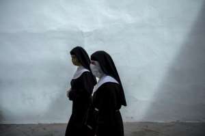 Two nuns wearing face masks walk in Seville as Spain prepares to ease its tough lockdown measures. By CRISTINA QUICLER (AFP)