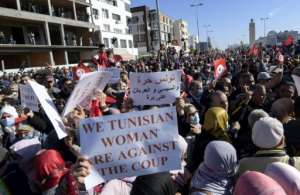 Tunisian demonstrators scuffle with security forces as they protest in front of parliament in Tunis. By FETHI BELAID (AFP)