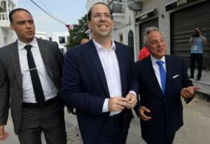 Tunisian Prime Minister Youssef Chahed arrives to cast his ballot at a polling station on the outskirts of the capital Tunis. By FETHI BELAID (AFP)