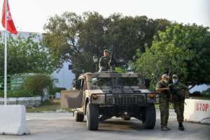 Tunisian soldiers cordon-off parliament in the capital Tunis on Monday, following the president's dismissal of the prime minister and suspension of parliament. By FETHI BELAID (AFP)