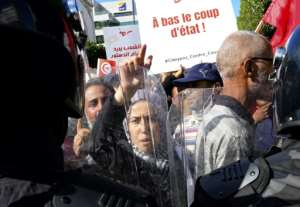 Tunisians face riot police during a rally against President Kais Saied in Tunis on October 10, 2021. More than 5,000 people, according to observers, flocked to the downtown Avenue Bourguiba. By FETHI BELAID (AFP/File)