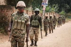 Ugandan troops pictured on Monday near the street leading to Bobi Wine's home. By YASUYOSHI CHIBA (AFP)