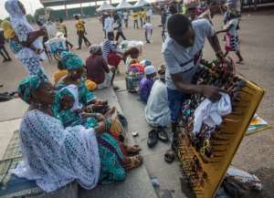 Vendors sell merchandise in Independence Square in Accra.  By CRISTINA ALDEHUELA (AFP/File)