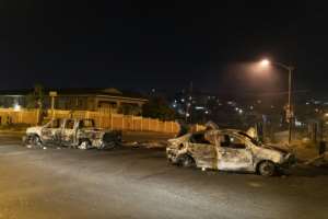 Violence: Burned cars litter the streets of the township.  By GUILLEM SARTORIO (AFP)