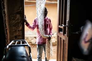 Viannay Kambale, 31, survived the Ebola virus and now works with patients at an Ebola treatment centre as he is immune to the disease. By JOHN WESSELS (AFP)