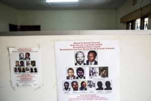 Wanted: A poster showing suspects at the headquarters of the fugitive genocide tracking unit, which, 25 years later, continues to hunt down the perpetrators of the mbadacre. By Jacques NKINZINGABO (AFP)