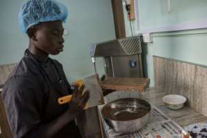 Waste not: Scraping excess chocolate from a mold. By CRISTINA ALDEHUELA (AFP/File)