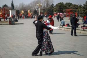While the crisis deepens in much of the world, some in China are returning to a normalcy of sorts. By STR (AFP)