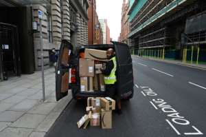 With shops closed in many countries or people reluctant to go to crowded stores, Amazon saw a surge in business. By Paul ELLIS (AFP/File)