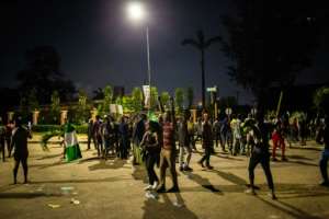 Witnesses said gunmen opened fire on a crowd of over 1,000 people to disperse them after a curfew was imposed to end spiralling protests. By Benson Ibeabuchi (AFP)
