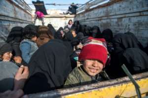 Women and children loaded into the back of a truck on February 11, 2019 after fleeing IS' shrinking pocket of territory in Syria. By Fadel SENNA (AFP/File)