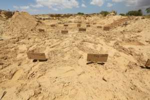 Wooden signs mark the makeshift tombs of African migrants whose bodies were found off Tunisia in a communal cemetery of El Ketif, near the coastal town of Zarzis, in the east of the country . By FATHI NASRI (AFP)