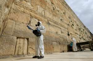Workers sanitise the Western Wall, the most holy site where Jews can pray against the spread of the coronavirus COVID-19 in Jerusalem.. By Emmanuel DUNAND (AFP)