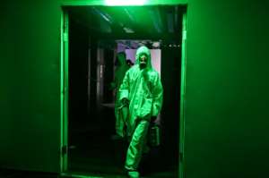 Workers wearing protective clothing disinfect a hotel as a preventive measure against the COVID-19 coronavirus in Yangon, Myanmar. By Ye Aung THU (AFP)