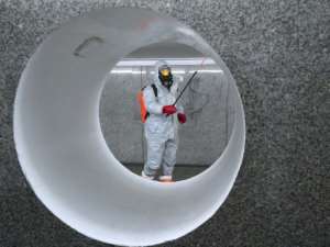 Workers wearing protective suits spray disinfectant at a subway station in Warsaw. By JANEK SKARZYNSKI (AFP/File)