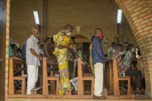 Worshippers were required to wash their hands with chlorinated water before entering the sanctuary, where they were kept a metre apart. By ARSENE MPIANA (AFP)