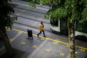Yellow footprints mark places for social distancing at a tramway dock in Nantes, France. By Loic VENANCE (AFP)