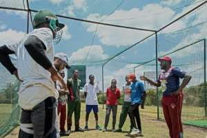 'Youth development is at the heart of cricket': Former Kenya wicket-keeper, David Obuya (R) talks to young players at the Obuya Cricket Academy. By Tony KARUMBA (AFP)