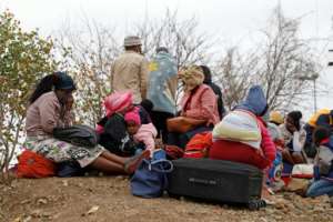 Zimbabweans await their fate after being caught trying to cross into South Africa to buy groceries. By Phill Magakoe (AFP)