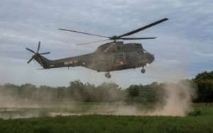 A helicopter from the Malawi Defense Force takes off after delivering aid - Bangula camp is cut off by land. By AMOS GUMULIRA (AFP)