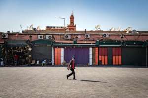 A man walks by mostly-closed stalls at the Jemaa el-Fna square in the Moroccan city of Marrakesh on September 8, 2020. By FADEL SENNA (AFP)