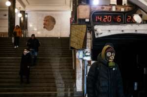 A man wearing a gas mask waits on the platform at the Biblioteka Imeni Lenina metro station in Moscow. By Dimitar DILKOFF (AFP)
