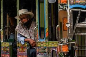 A man wearing a face mask on a bus in Colombia on May 18, 2020. The force of the pandemic is beginning to be felt in Latin America. By JOAQUIN SARMIENTO (AFP)