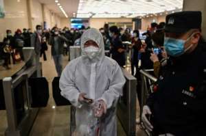 A man wearing a protective suit arrives at Hankou Railway Station in Wuhan to board one of the first trains leaving the city. By Hector RETAMAL (AFP)
