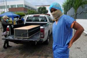 A man wearing a protective suit to identify a relative outside the morgue of the Hospital General Guasmo Sur in Guayaquil, Ecuador. By Jose Sánchez (AFP)