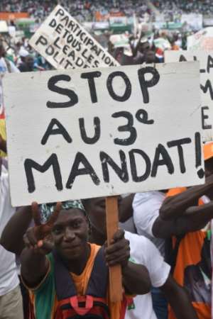 A man holds a placard reading