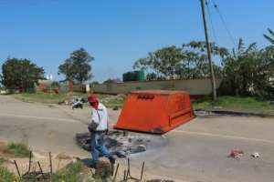 A man passes by a blocked road in the Msunduza towship of Mbabane on October 20, 2021. By - (AFP)